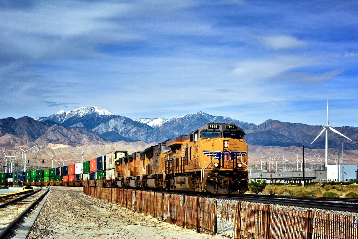 Palm Springs, California, USA - January 14, 2018: Overseas Freight containers being transported on a Union Pacific Railroad train passing nearby Palm Springs, Coachella Valley, Western USA.